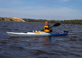 Kayakers glides through the waters of Grand Sable Lake.