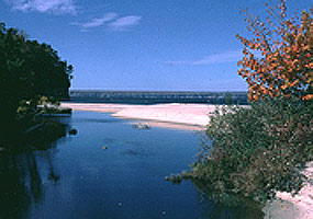 The Miners River flows toward Lake Superior on a clear summer day.