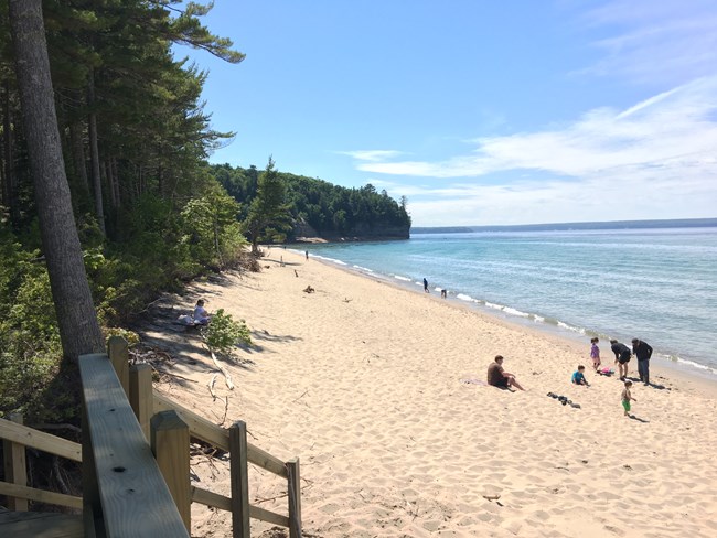 A few people enjoying a sunny day at Miners Beach