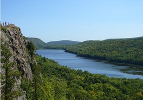 The beautiful Lake of the Clouds is surrounded by towering hills with lush green northwoods vegetation. 