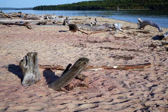 Pink sand from garnet is clearly visible on the beach with Lake Superior in the background.