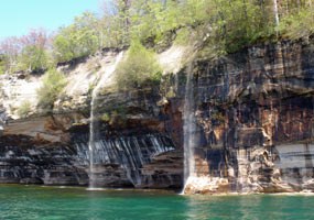 Springtime waterfalls tumble over the Pictured Rocks cliffs into Lake Superior. Springtime waterfalls tumble over the Pictured Rocks cliffs into Lake Superior.