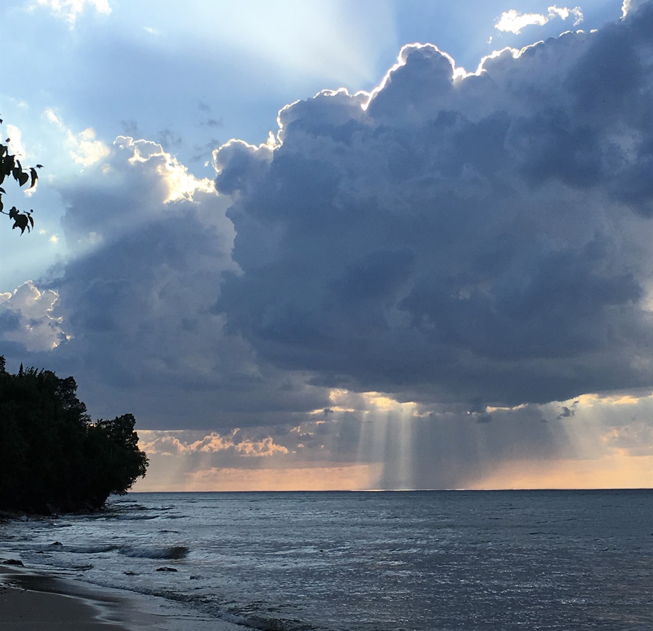 Dramatic storm clouds at sunset over the lake