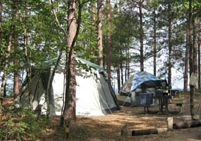 A tent nestled at a campsite along Twelvemile Beach on Lake Superior.