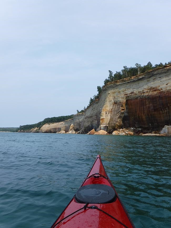 kayaking in Pictured Rocks Kayaker in Lake Superior near Pictured Rocks