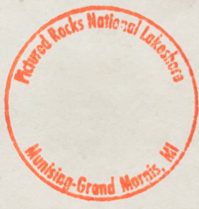 Pictured Rocks NL Passport Stamp. Text wraps inside an orange circle.