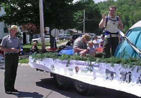 Superintendent Northup with the lakeshore's entry in the Munising Fourth of July parade. The float featured park employees with their children and highlighted recreational opportunities at the lakeshore such as camping, fishing, birding, and kayaking.