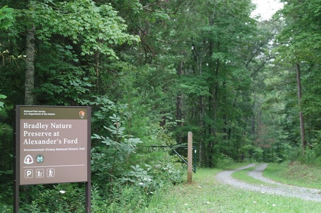Bradley Nature Preserve at Alexander's Ford sign is to the left of a gravel road.
