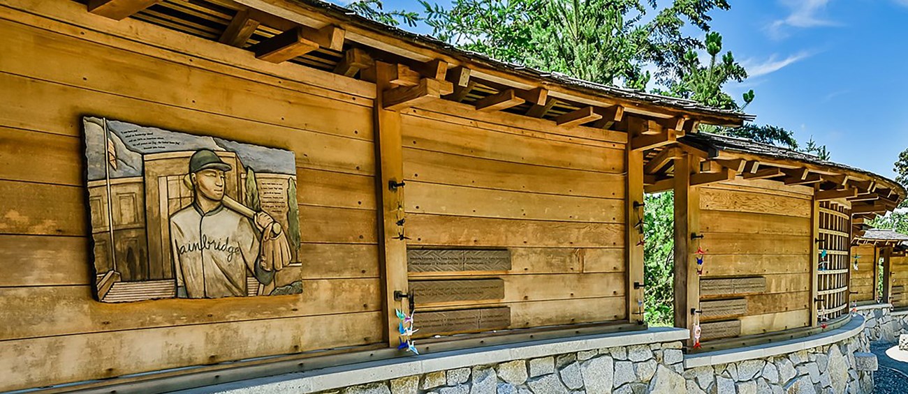 curved wall of cedar and stone