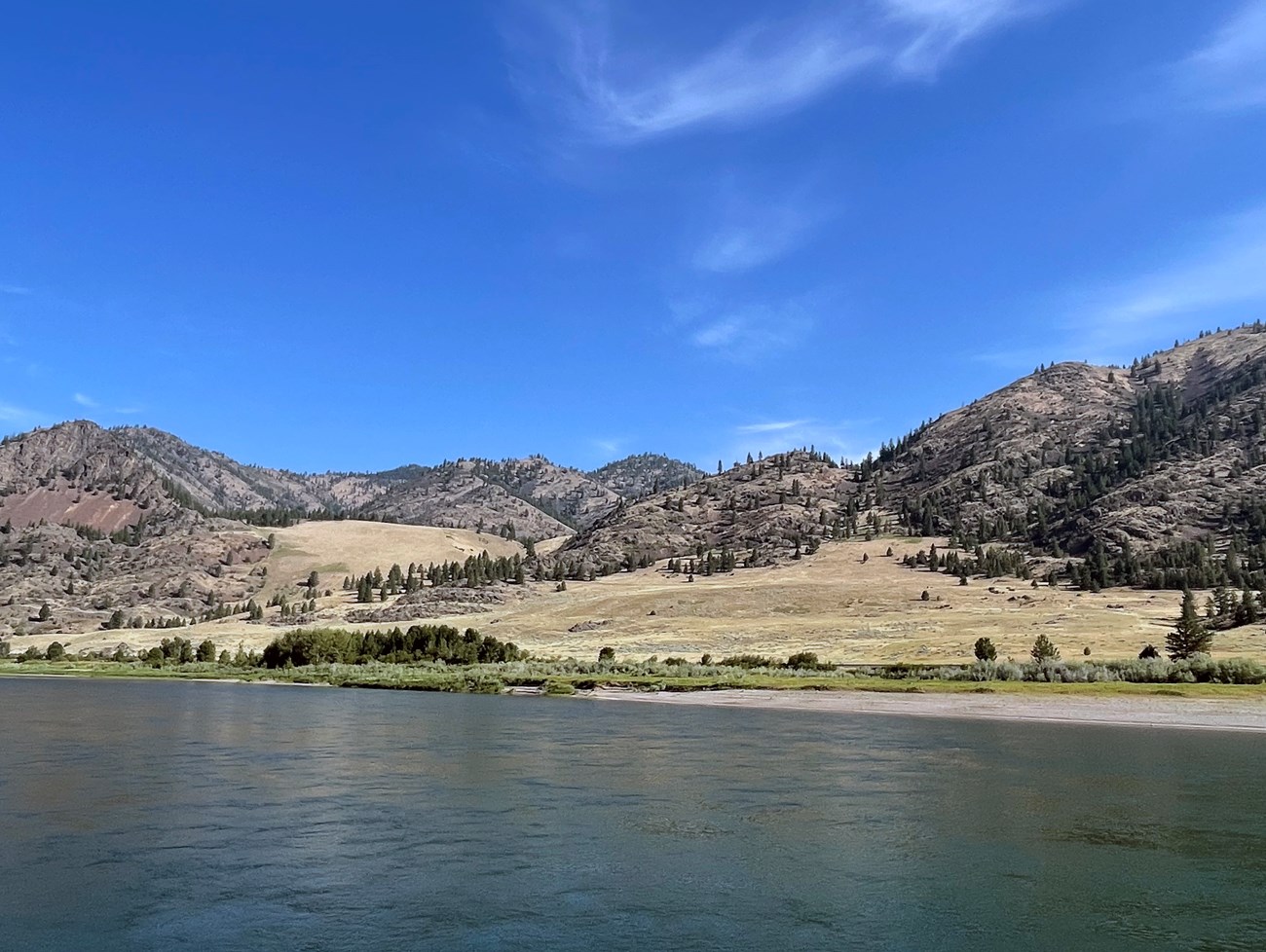 River with mountain and blue sky in the background