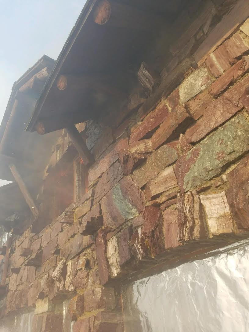 Flames were first observed at the chalet coming from the interior of the building, as pictured here in the upper left with this blown out window. NPS Photo