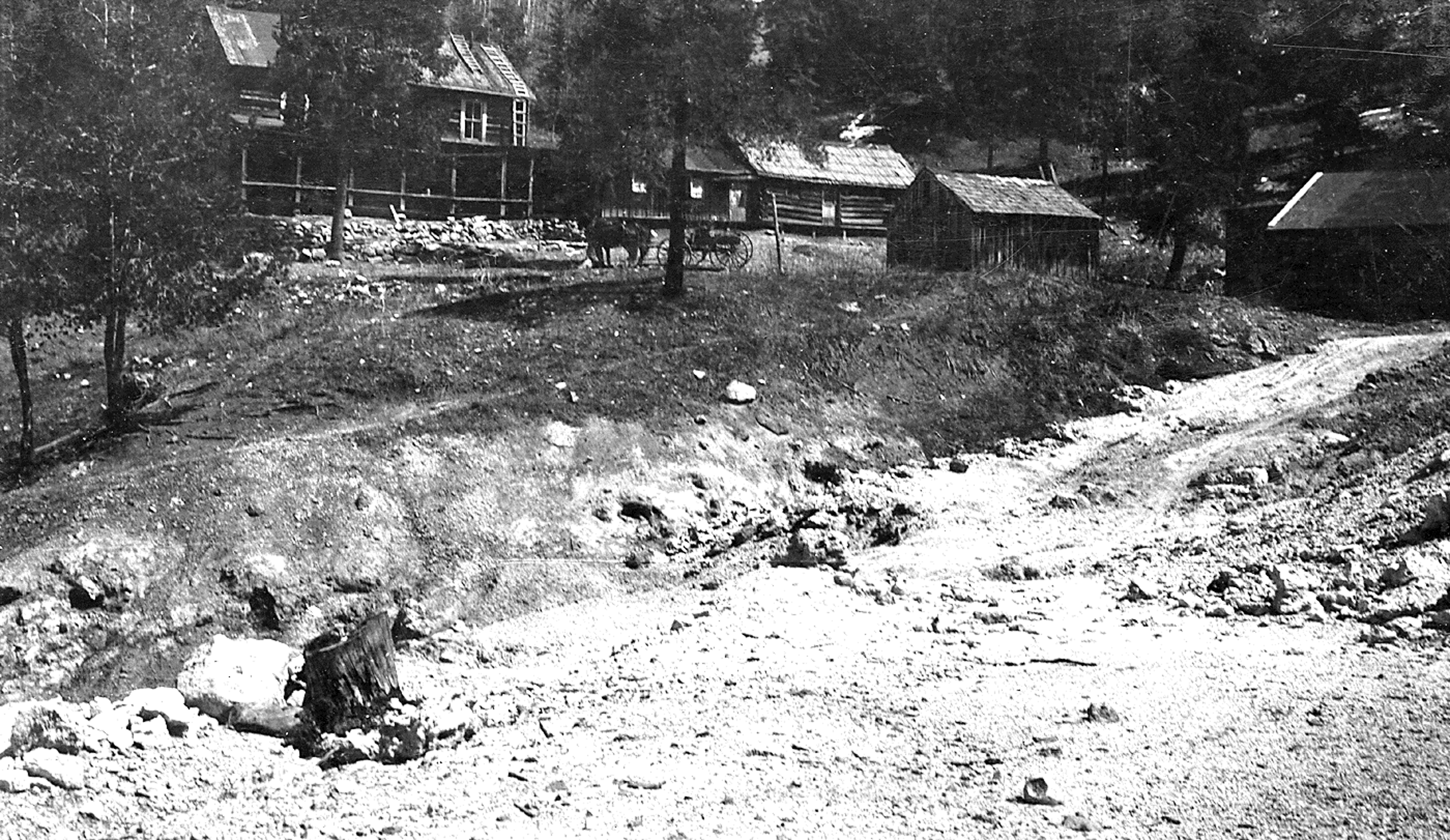 Sulphur Springs 1918 Photo of Sulphur Springs hotel and bath houses, April 16, 1918. Photo is black and white with buildings, tree and a horse-drawn carriage.