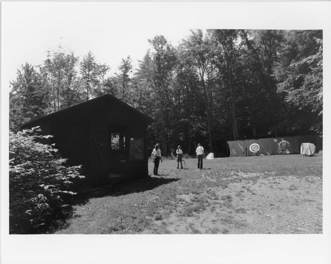 Three young girls practicing archery