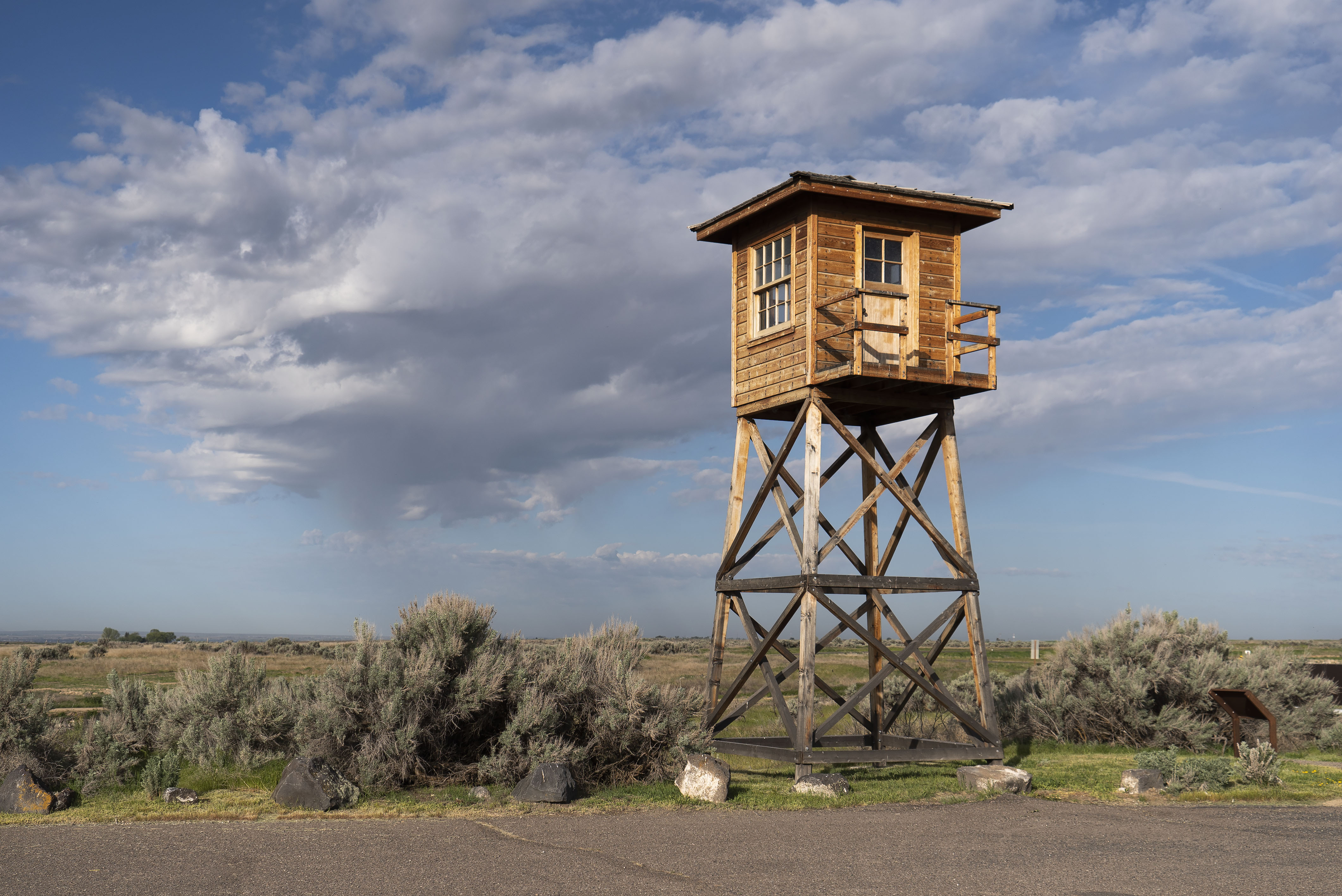 guardtower_DSC1924 Wooden guard tower standing in open desert on a partly cloudy day.