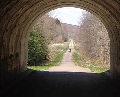 View inside of a tunnel as a bike travels in the distance