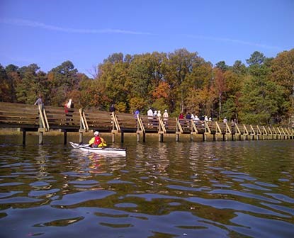 Kayaker nears a pedestrian bridge