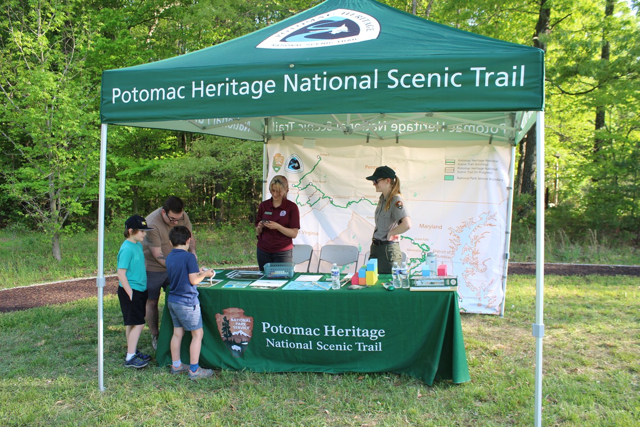 Visitors learning from park staff at an event
