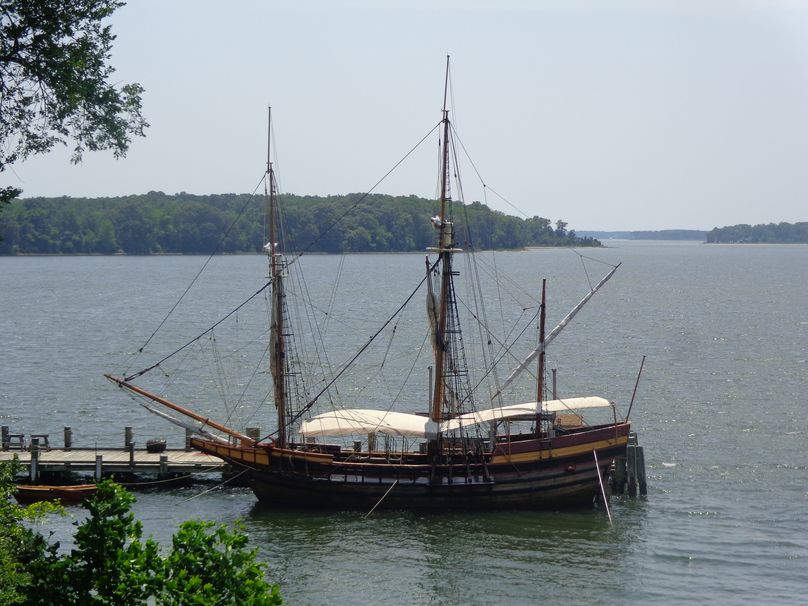 A docked boat sits in a peaceful body of water.