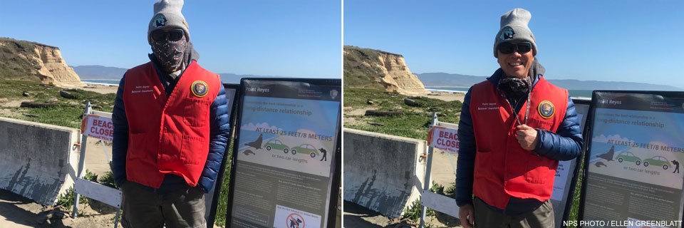 Two photos of a docent wearing a red docent vest and a gray knit cap standing next to some signs at a beach. The left photo shows Jeff wearing a mask; the right photo without.