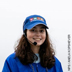 A head photo of Latino Heritage Internship Program Intern Alícia wearing a blue windbreaker and ball cap.