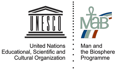 The logos for the United Nations Educational, Scientific and Cultural Organization (UNESCO) and Man and the Biosphere Programme (MAB). Two logos side by side: a cartoon of a classical building with the letters UNESCO serving as pillars; a blue, green, white and red rainbow with the letters MAB.