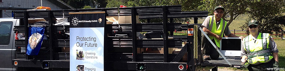 Earth Day E-waste Collection at Bear Valley on April 22, 2013. Two uniformed park employees loading electronic waste into a gray stake bed truck.