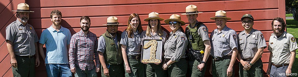 Eleven members of the Point Reyes National Seashore's Social Media Team standing in front of a red building. Eleven members of the Point Reyes National Seashore's Social Media Team standing in front of a red building.