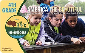 Image of the 2022–2023 Every Kid Outdoors Pass, featuring a photo of children looking down over a wooden railing and pointing at something out-of-camera.