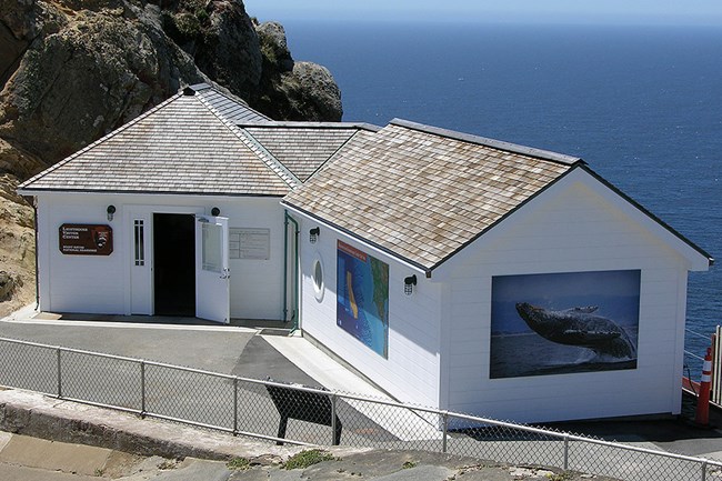 The Point Reyes Lighthouse Visitor Center and Ocean Exploration Center with the Pacific Ocean in the background.