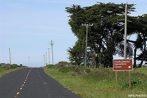 A white on brown sign reading "North District Operations Center" alongside of a road.