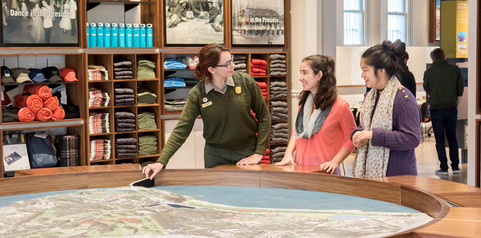 Park ranger pointing out location on map for visitors