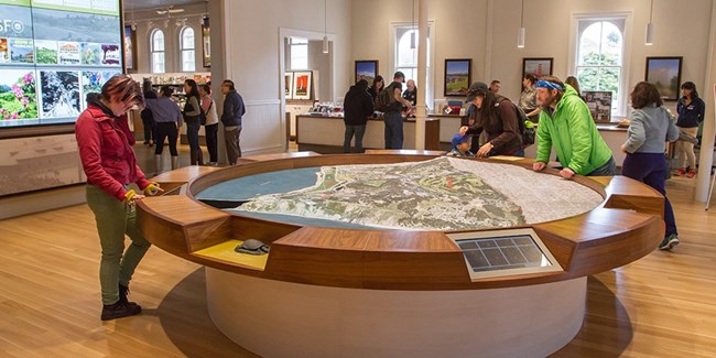 People looking at interpretive table.