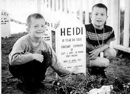 The sons of Capt. J. K. Moore pay tribute to their collie, Heidi, in 1957.