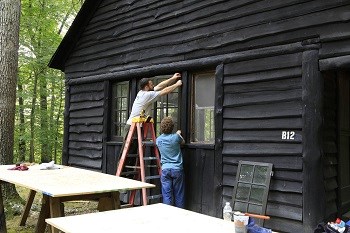 Volunteers working on a historic cabin