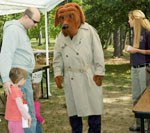 McGruff the crime prevention dog providing information to a family.