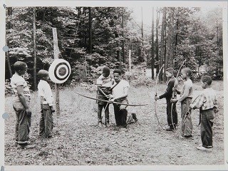 Young campers learning archery