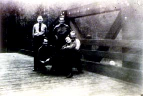 CCC boys pose on bridge.