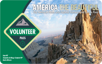 2023 Volunteer Pass, green with a photo of a rocky mountain