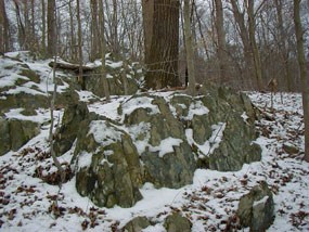 Stop E of the geology e-walk, rocks covered in snow along a trail