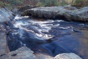 Stop I on the geology e-walk, large rock exposure along Quantico Creek