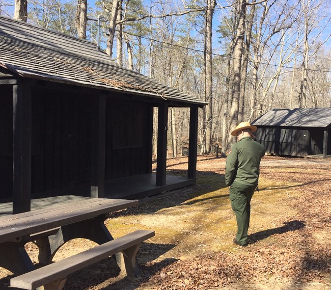 A park ranger walks through Cabin Camp 3