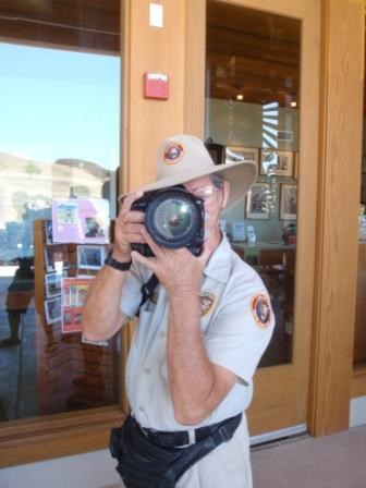 Volunteer taking photo with lens pointed at the viewer.