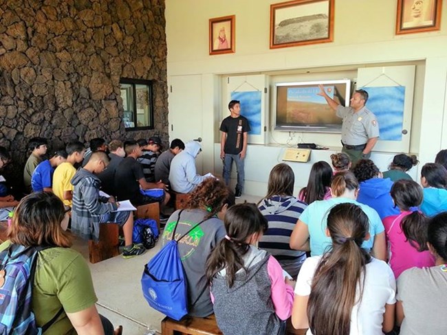 A park ranger gives a presentation to students.