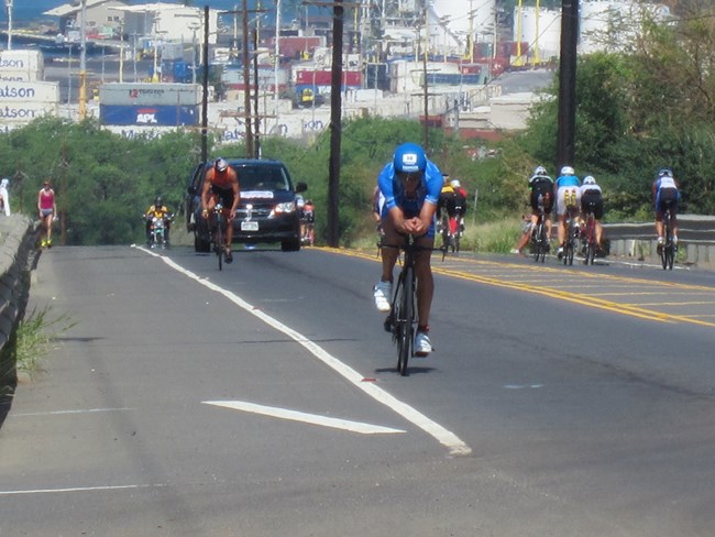 Ironman bikers passing park entrance