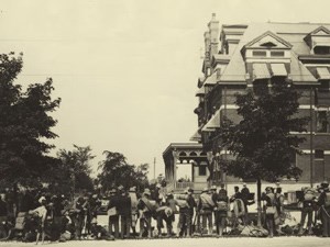 Black and white photograph of National Guard Troops standing in front of Hotel Florence.