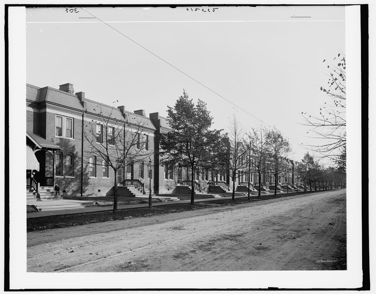 Black and white photo of brick row houses.