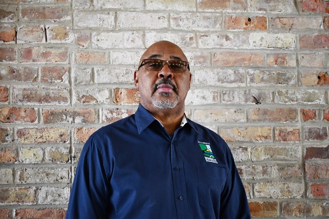 Levi Brey 2022 A man wearing glasses wears a navy blue polo with the Illinois Department of Natural Resources logo.