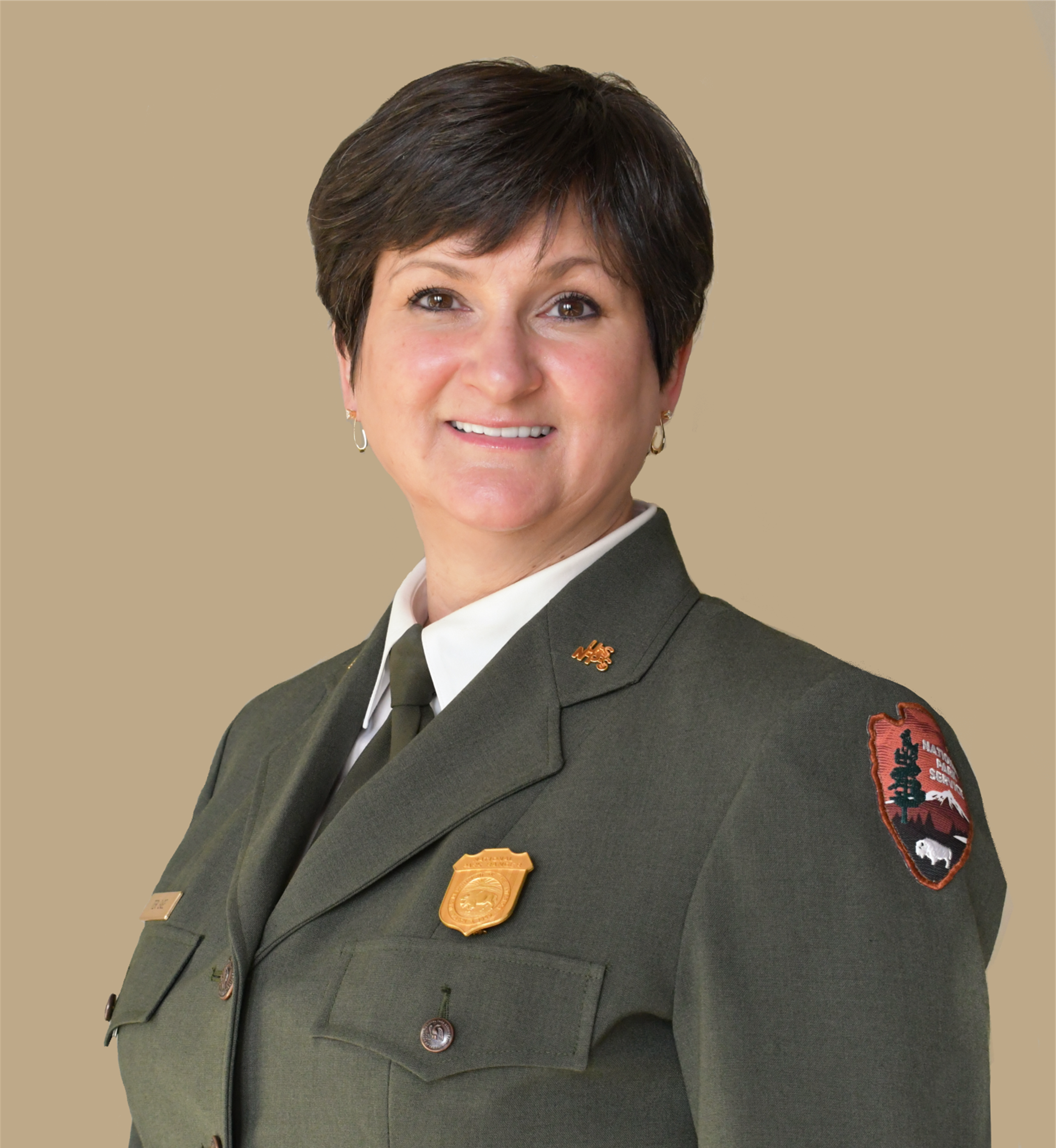 TERI_Headshot Women smiles wearing nps green formal jacket