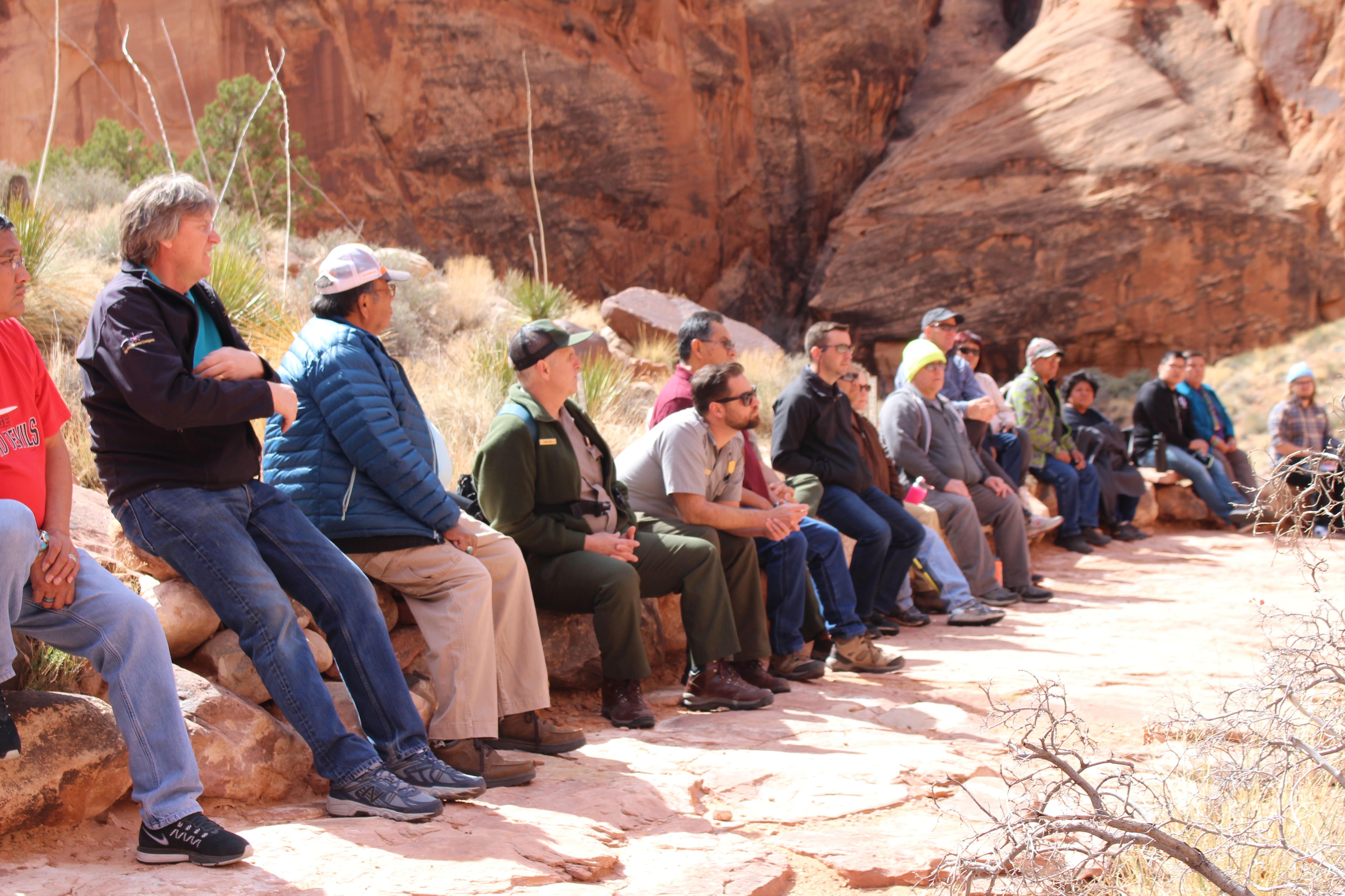 Group of people line up on a sandstone outcrop