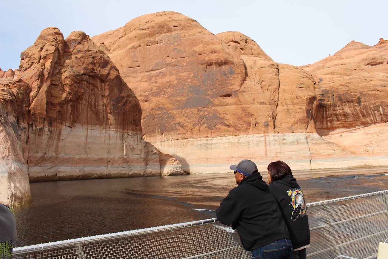 Couple enjoys ride through canyon on tour boat observation deck